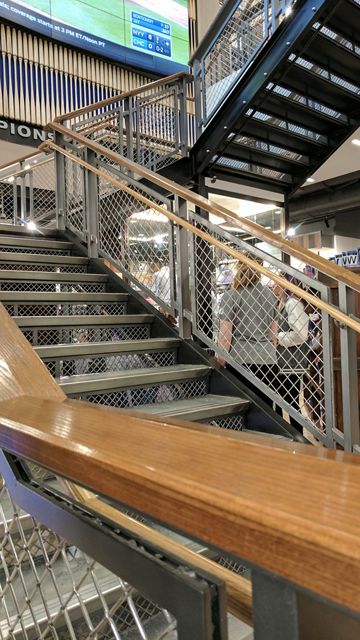 McNICHOLS Wire Mesh railing infill panels enhance this staircase in a Chicago Cubs retail store