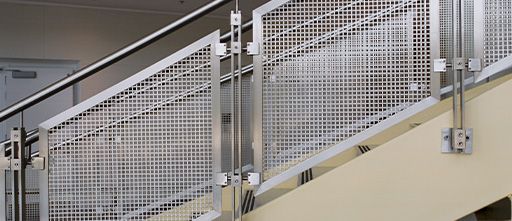Photo of a staircase and railing that has Wire Mesh Infill Panels.